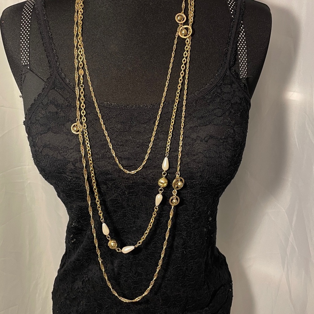 Extra long gold tone chains adorned with charms to create a layered look